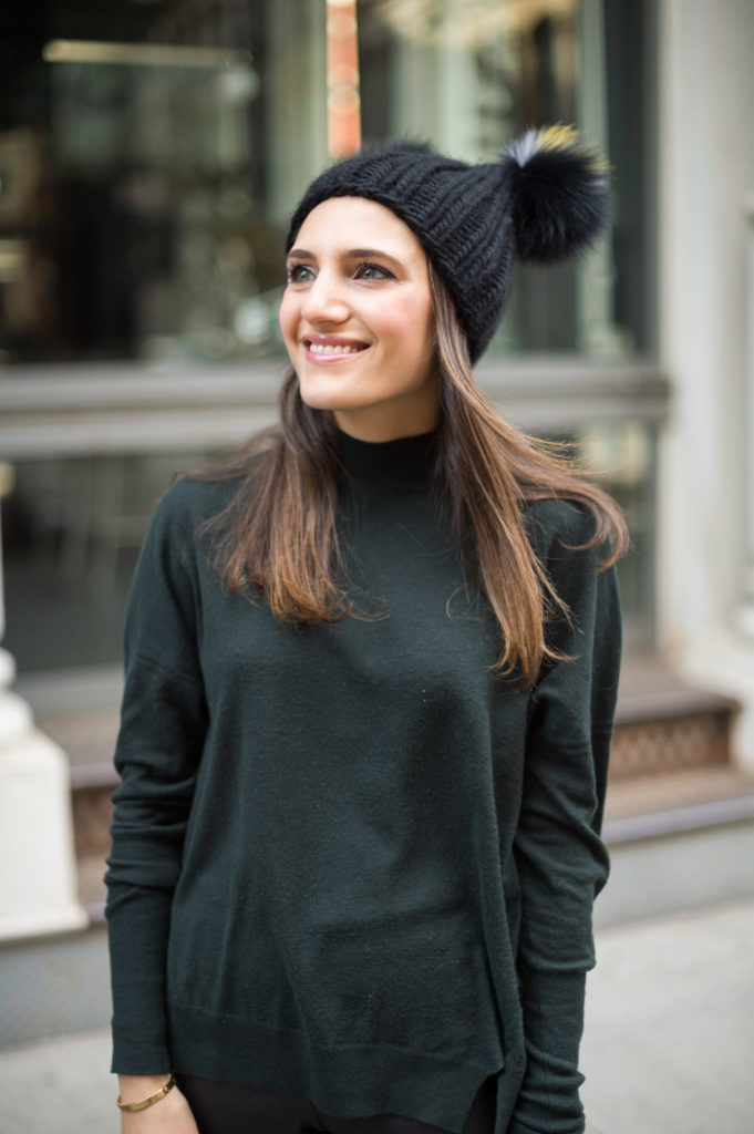 Lifestyle blogger Amanda Warsavsky wearing a J Brand turtleneck sweater and Eugina Kim hat