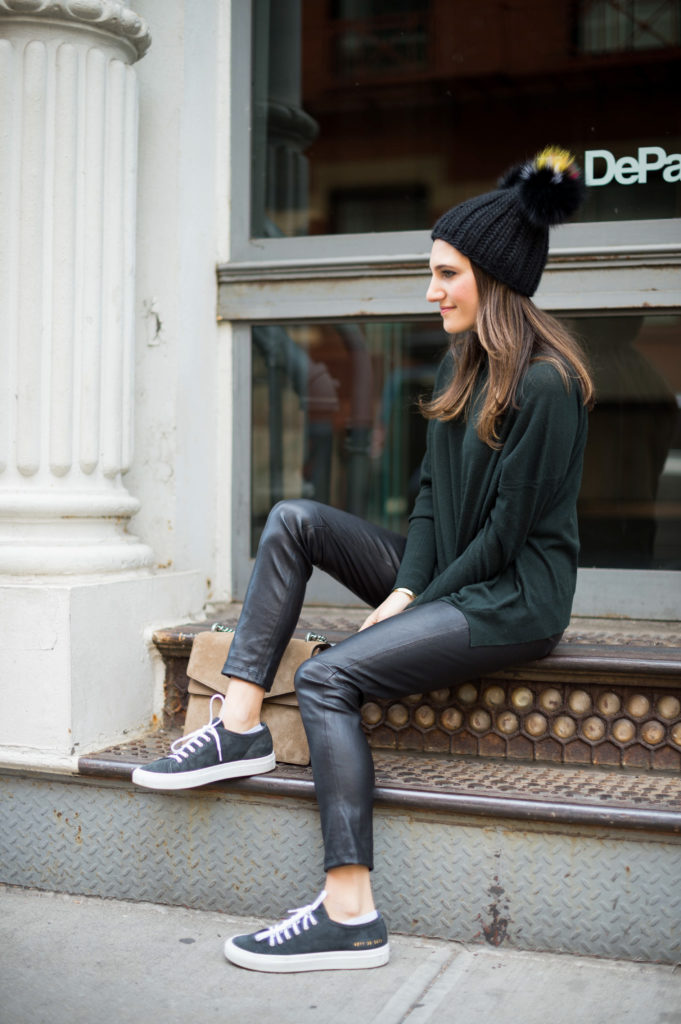 Lifestyle blogger Amanda Warsavsky wearing a J Brand turtleneck sweater, leather leggings, Common Projects sneakers and Eugina Kim hat