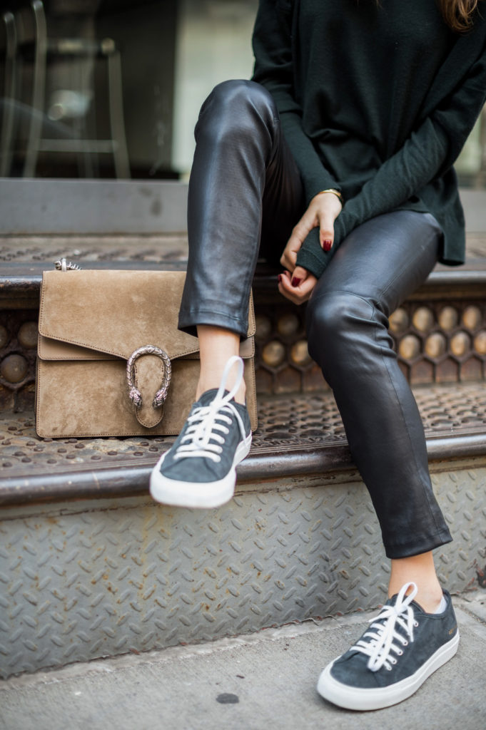 Lifestyle blogger Amanda Warsavsky wearing a J Brand turtleneck sweater, leather leggings, and Common Projects 