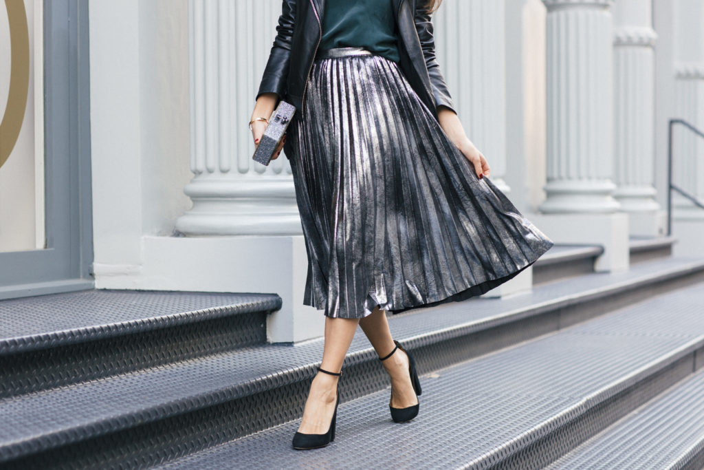 Lifestyle and corporate fashion blogger Amanda Warsavsky wearing a silver pleated skirt and black leather jacket for holiday inspiration