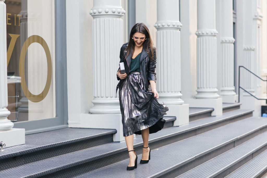 Lifestyle and corporate fashion blogger Amanda Warsavsky wearing a silver pleated skirt and black leather jacket for holiday inspiration