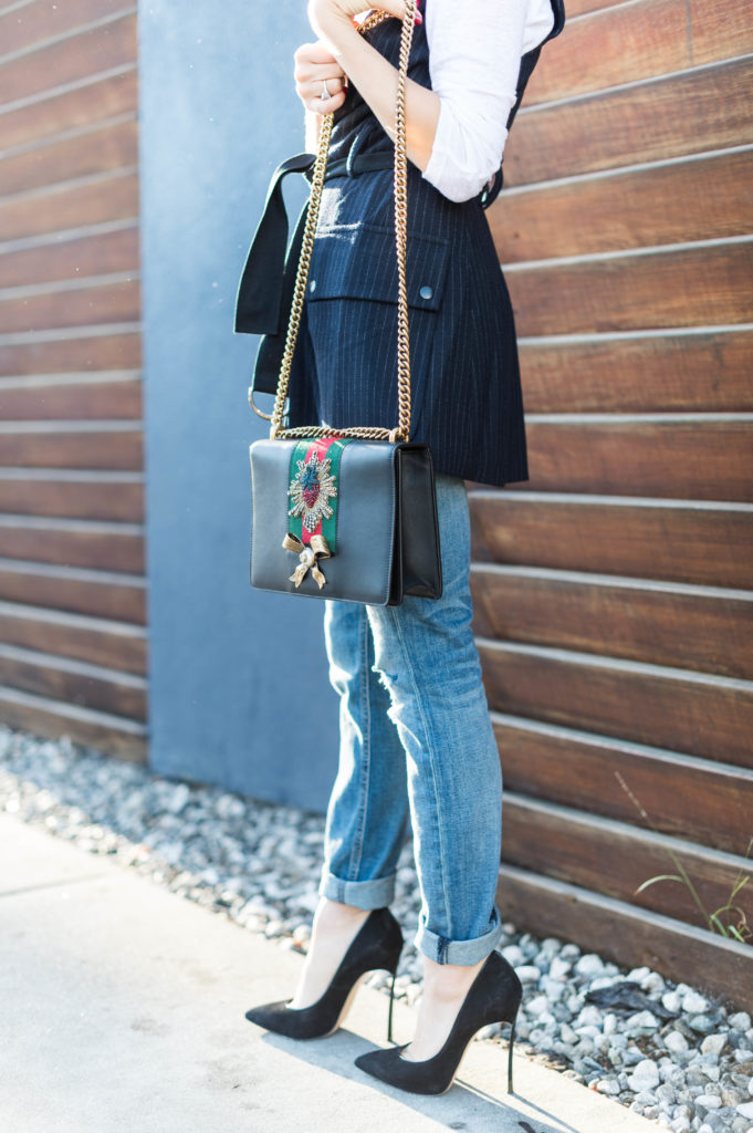 Lifestyle and corporate blogger That Pencil Skirt wearing a Marisa Webb vest and Rag, Bone boyfriend jeans, and a Gucci purse