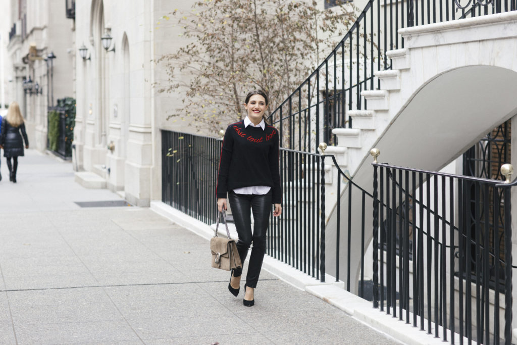 Lifestyle and corporate blogger That Pencil Skirt wearing leather pants, a Cinq a Sept sweater, white button down blouse and Gucci bag