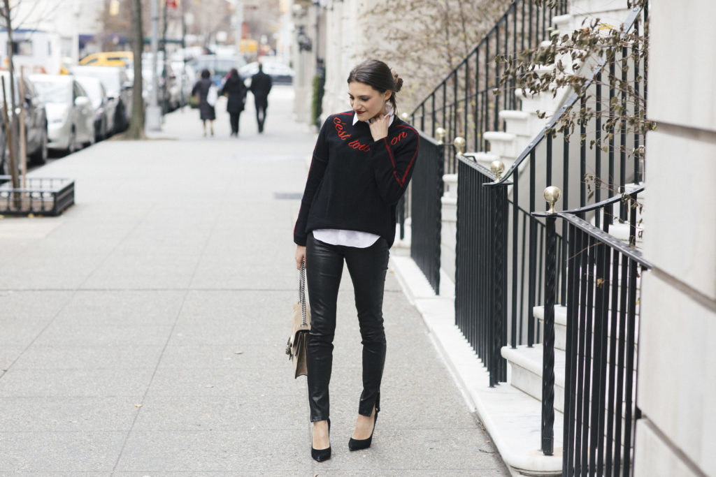 Lifestyle and corporate blogger That Pencil Skirt wearing leather pants, a Cinq a Sept sweater, white button down blouse and Gucci bag