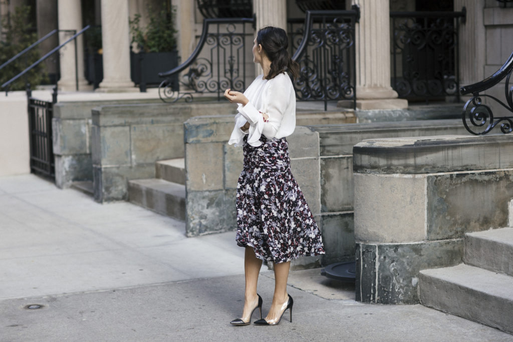 Corporate blogger Amanda Warsavsky wearing a Veronica Beard a line midi skirt, white ruffle top, and Gianvito Rossi leather and plexipumps