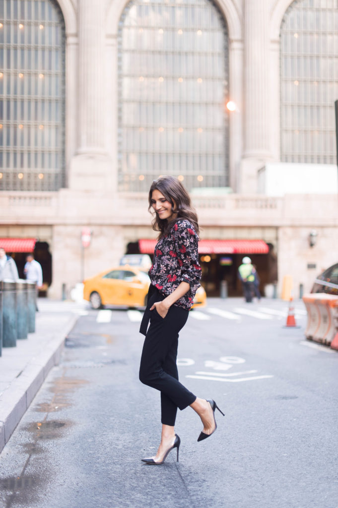 Lifestyle and work style blogger That Pencil Skirt wearing a black printed floral ba&sh blouse and tie waist black trousers