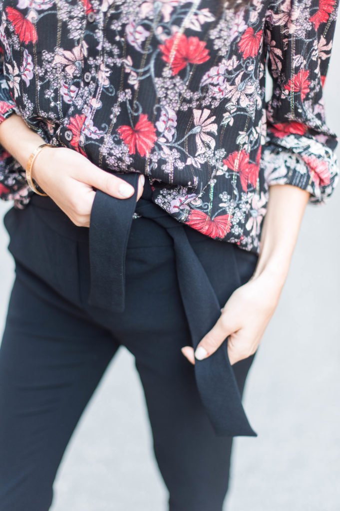 Lifestyle and work style blogger That Pencil Skirt wearing a black printed floral ba&sh blouse and tie waist black trousers