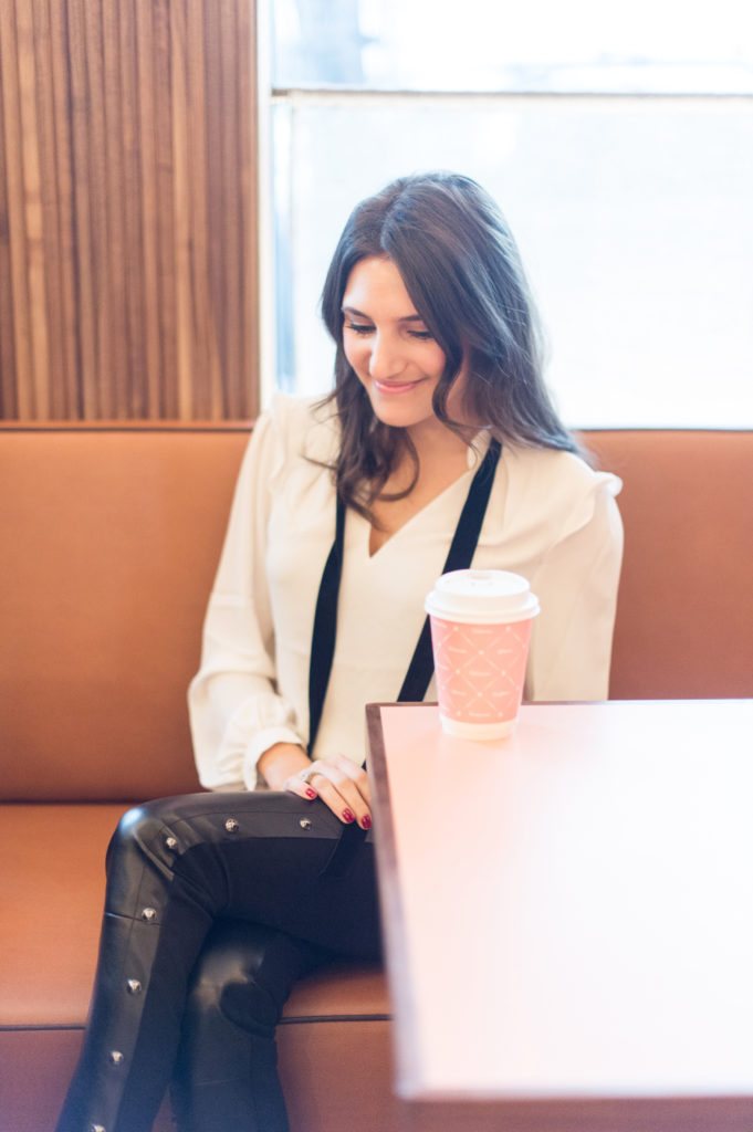 That Pencil Skirt, a lifestyle and work style blogger, wearing vegan leather pants, and a white blouse with a black velvet tie from thefrom the White House Black Market holiday collection