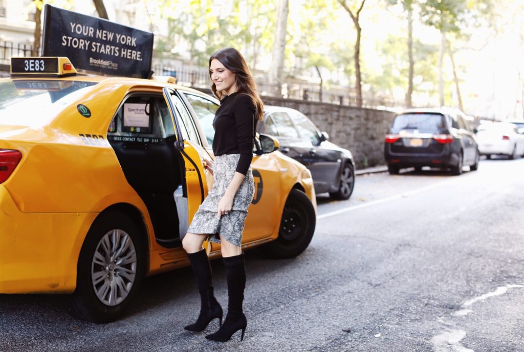 That Pencil Skirt, a lifestyle and work wear blogger, wearing an MM.LaFleur Noho pencil skirt in crackle print with a black stretch MM.LaFleur Winfrey longsleeve cotton top and Joie black suede over the knee boots