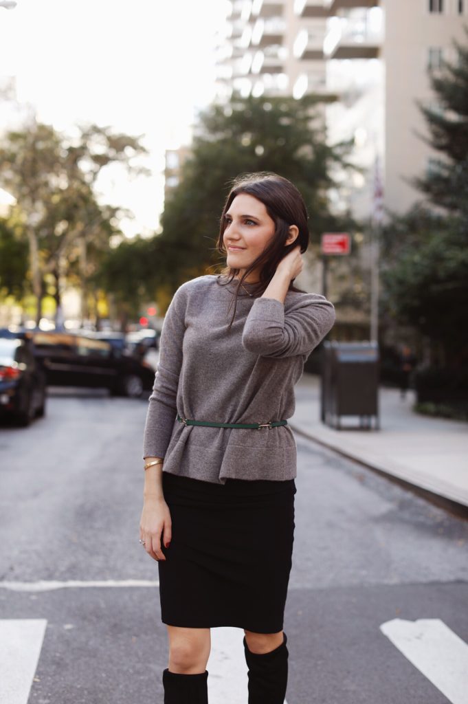 That Pencil Skirt, a lifestyle and work wear blogger wearing an MM.LaFleur Kendall sweater with a thin green belt and a black stretchy ruched skirt