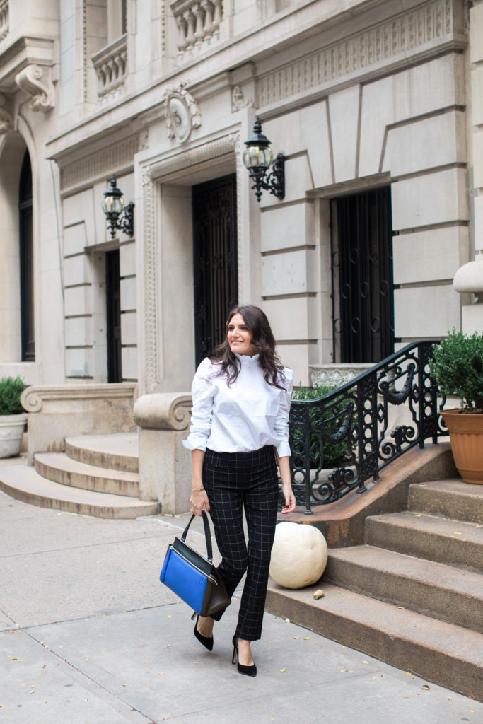 Lifestyle and workwear blogger That Pencil Skirt wearing a Frame ruffle collar Victorial blouse, Alice and Olicia Stacy windowpane pants, a Celine bag and black suede pointed toe Jimmy Choo pumps