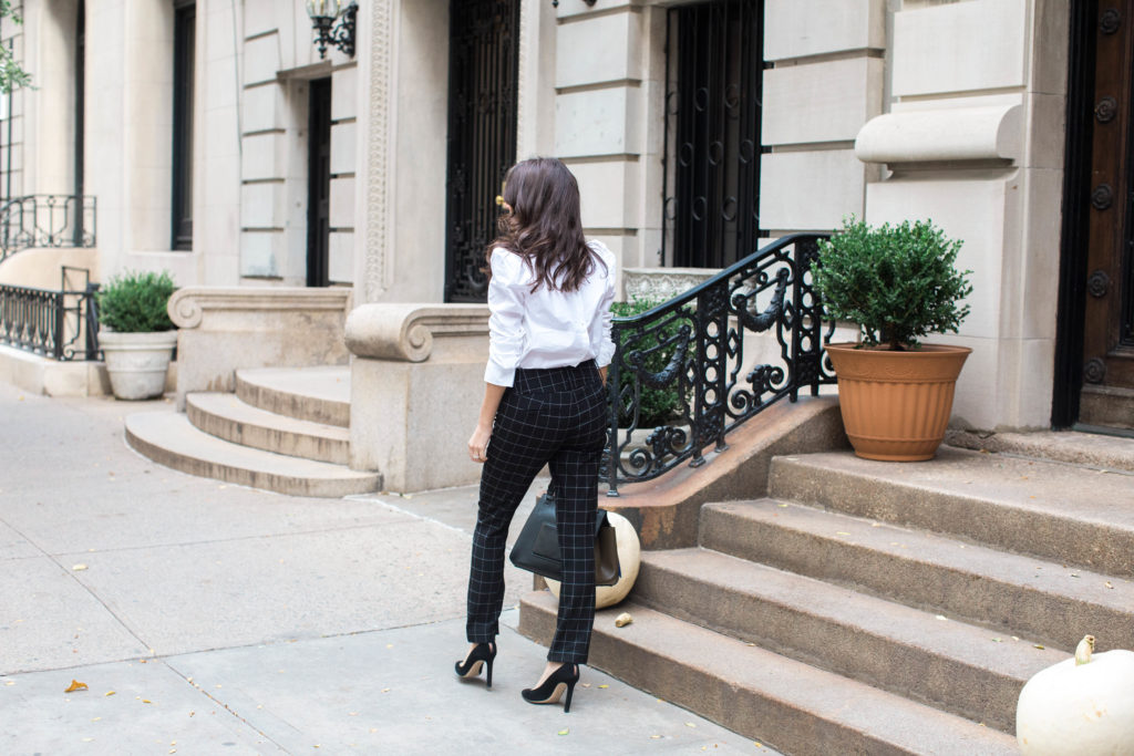 Lifestyle and workwear blogger That Pencil Skirt wearing a Frame ruffle collar Victorial blouse, Alice and Olicia Stacy windowpane pants, a Celine bag and black suede pointed toe Jimmy Choo pumps