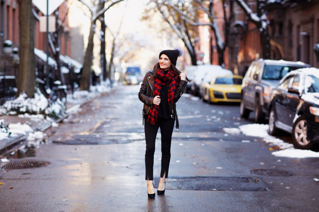 That Pencil Skirt, a lifestyle blogger, wearing Ann Taylor maternity friendly leggins with a front slit, a red and blue check scarf and a pom pom hat