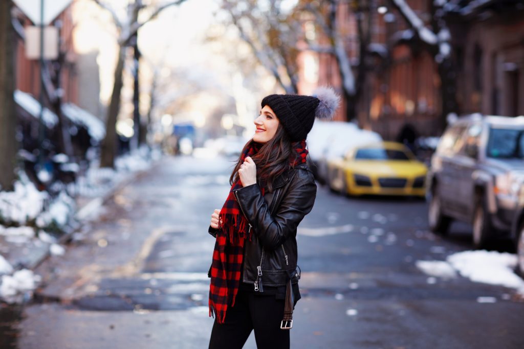 That Pencil Skirt, a lifestyle blogger, wearing Ann Taylor maternity friendly leggins with a front slit, a red and blue check scarf and a pom pom hat