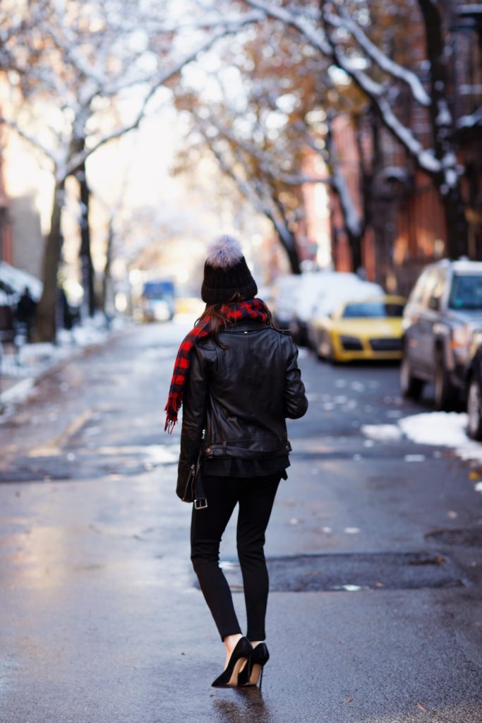 That Pencil Skirt, a lifestyle blogger, wearing Ann Taylor maternity friendly leggins with a front slit, a red and blue check scarf and a pom pom hat