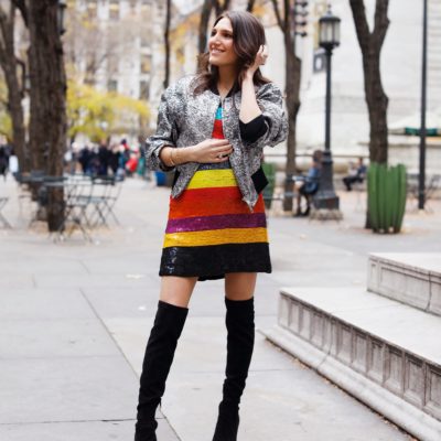 That Pencil Skirt, a fashion blogger, wearing an Alice and Olivia striped sequin color mini dress, with a Philip Lim silver embroidered bomber jacket and over the knee black suede boots